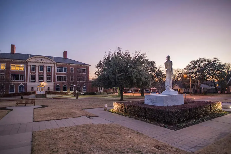 The TWU Minerva statue at dusk, pictured in front of the Visual Arts building.
