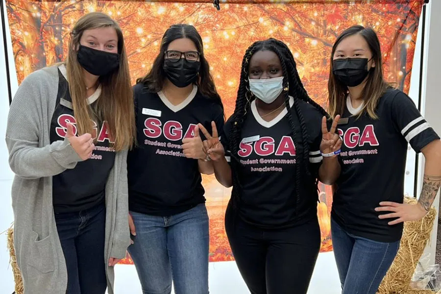 Four SGA members pose for a photo with protective face masks on