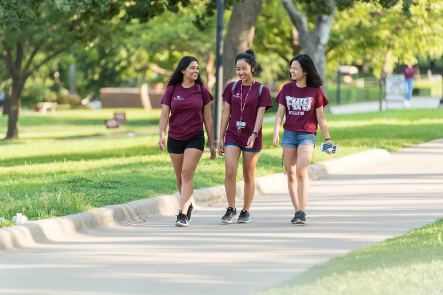 Three TWU students walking on TWU