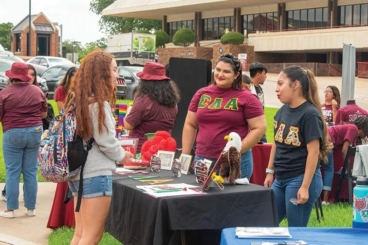 Sorority students talking to other TWU students during org fest.