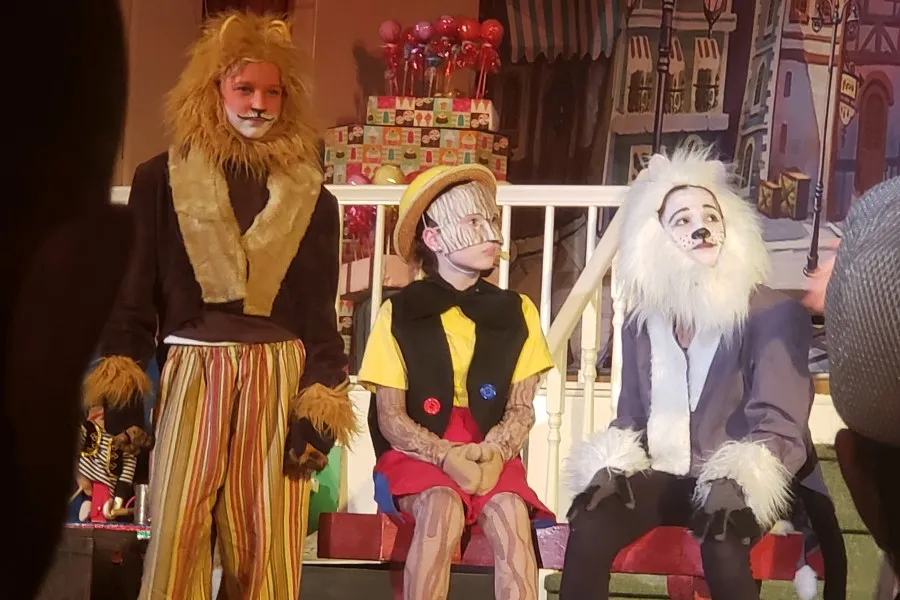 Three children dressed up as Wizard of Oz characters