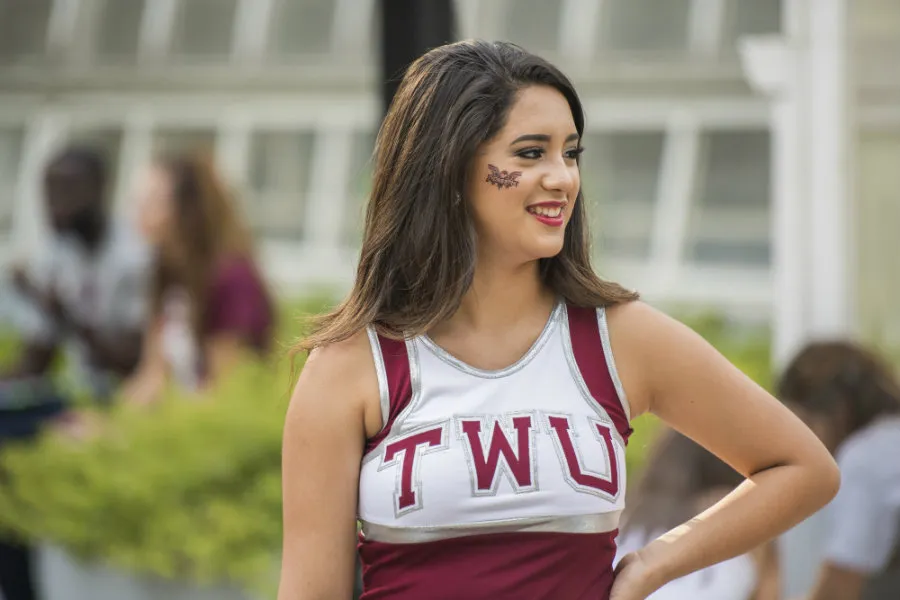 A TWU dancer in her maroon uniform and a stick-on tattoo of the Owl mascot.