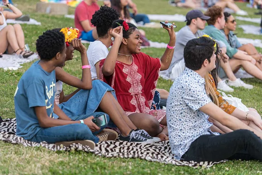TWU students relax and listen to music on the lawn of the Denton campus.
