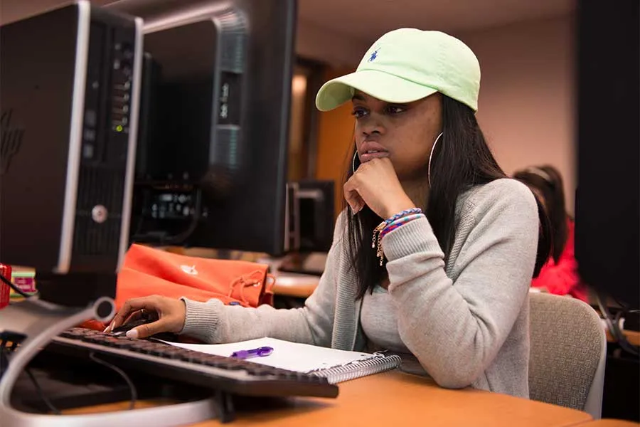 A TWU student works at a computer in a lab on the Denton campus.