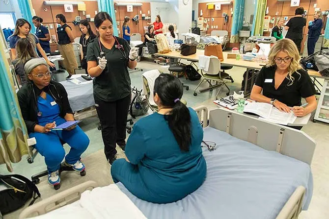 A bilingual medical interpreter speaks to a patient