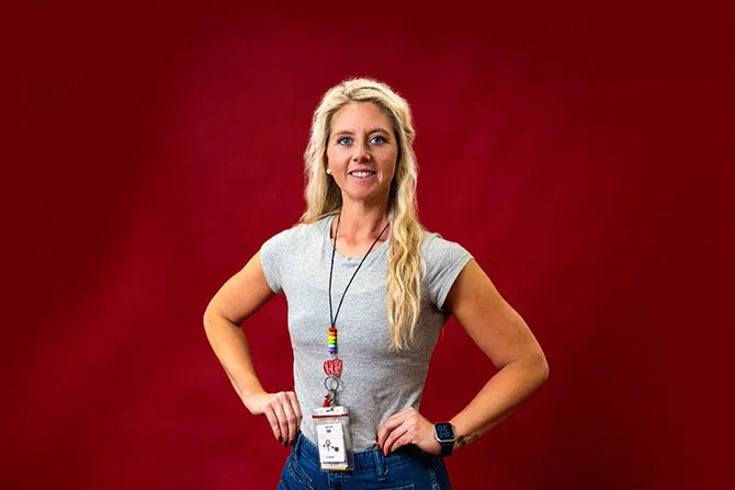 A portrait of a TWU graduate student that works full time as a teacher on a maroon background.