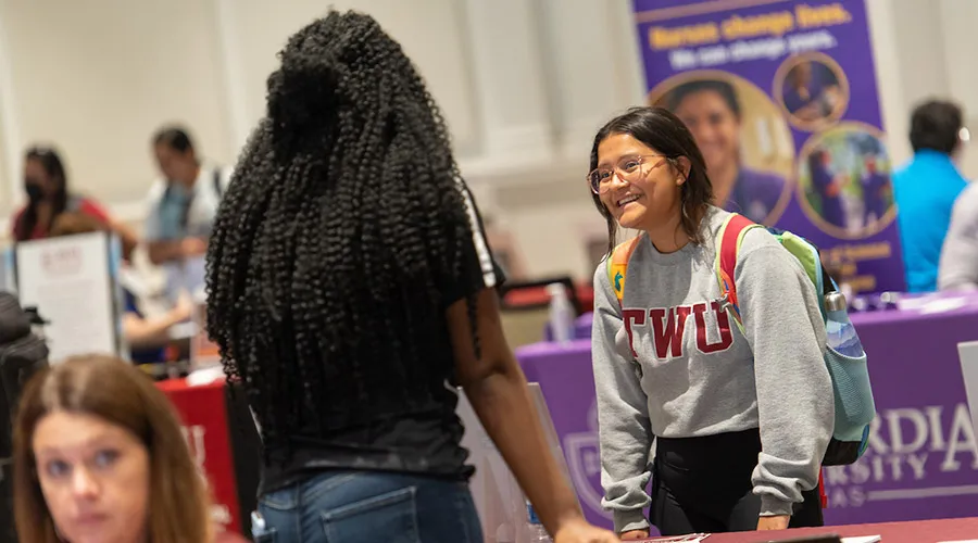 A TWU graduate student gets information from a vendor table