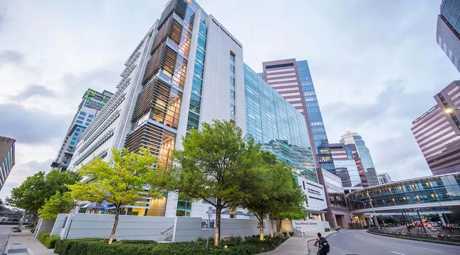 A student rides a bike near the TWU Institute of Health Sciences in Houston