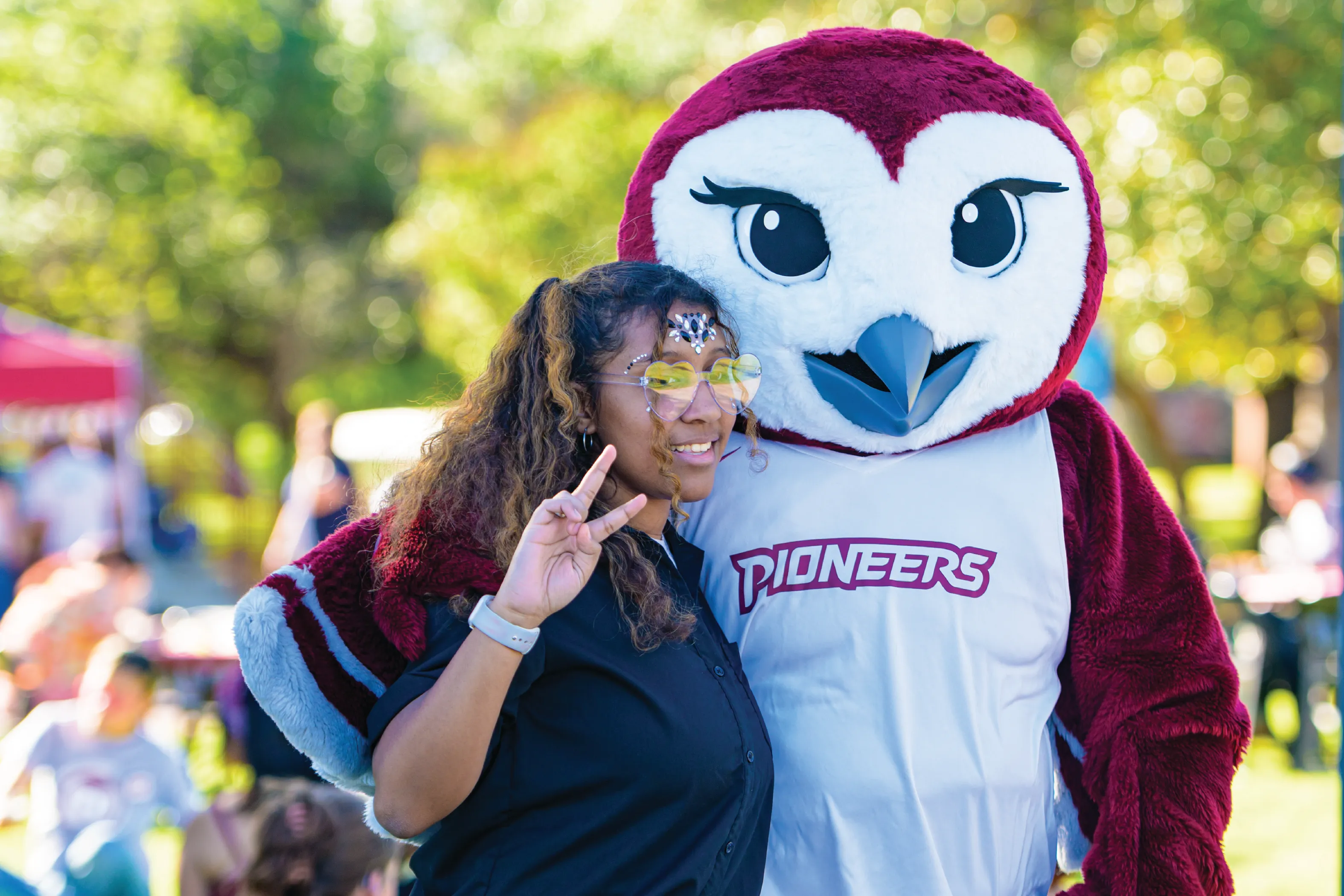 A TWU student at the annual Oakchella event poses for a photo with Oakley.