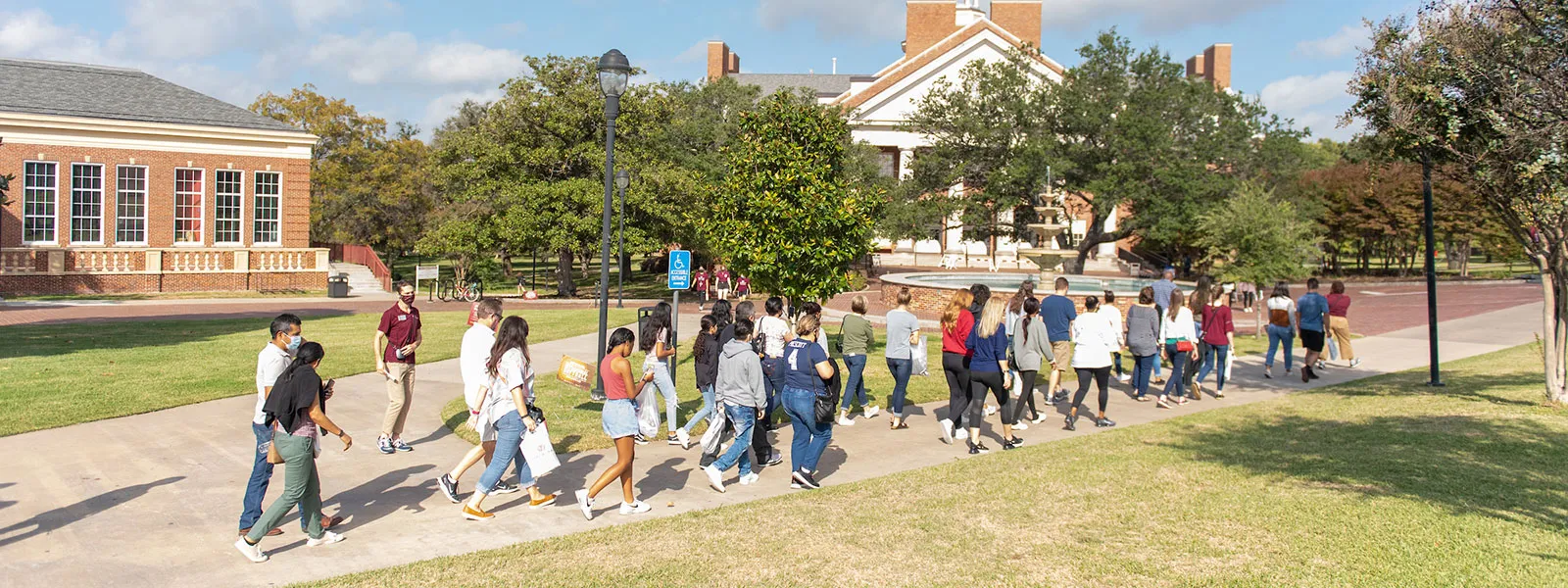 A TWU Pioneer Ambassador leads a group tour across the Denton campus