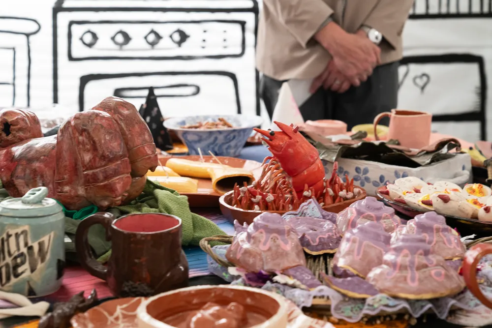 SUHH Installation, from JC Neidhart's ceramic course. Features ceramic food and surreal drawings