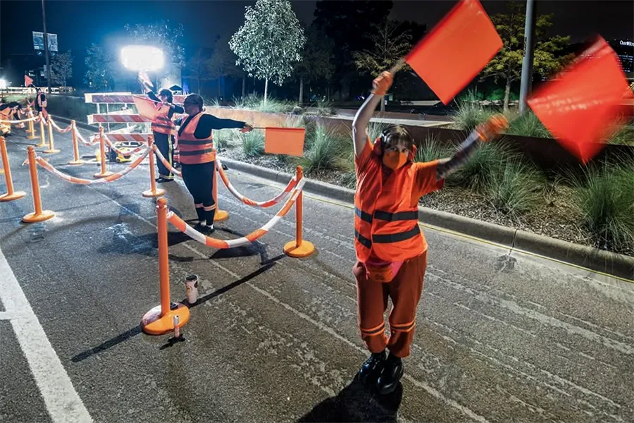 Dancer waves flags to cues in song, during Julie Libersat's, 