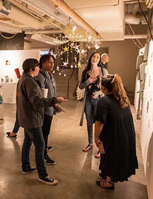 Students and community members touring the basement of the Art Building