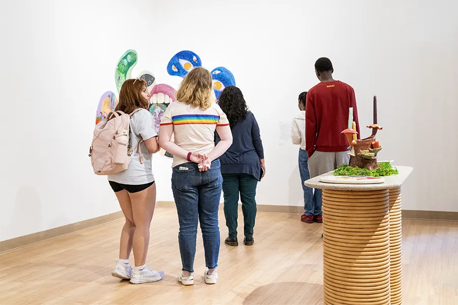 Students view work during recent BFA exhibition