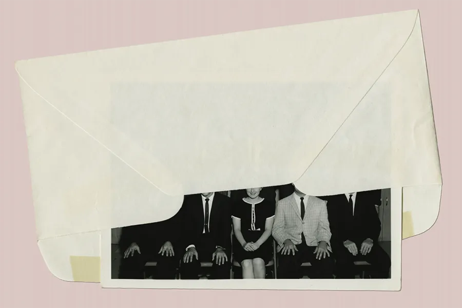 a white envelope lies on light pink background, a black and white photograph spills out of the envelope, faces obscured