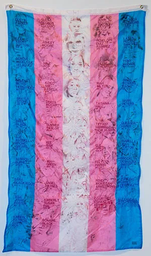 blue, pink, and white trans flag with photo transfers & embroidered names
