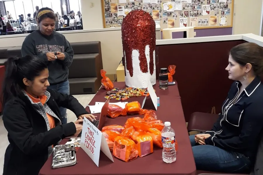 The Sexual Health Taskforce, a group of graduate students and faculty advocating for menstrual product access at TWU, drew students’ attention with their giant sparkly tampon and free menstrual products.