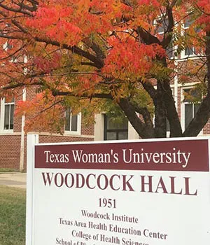 Exterior of Woodcock Hall with autumn leaves