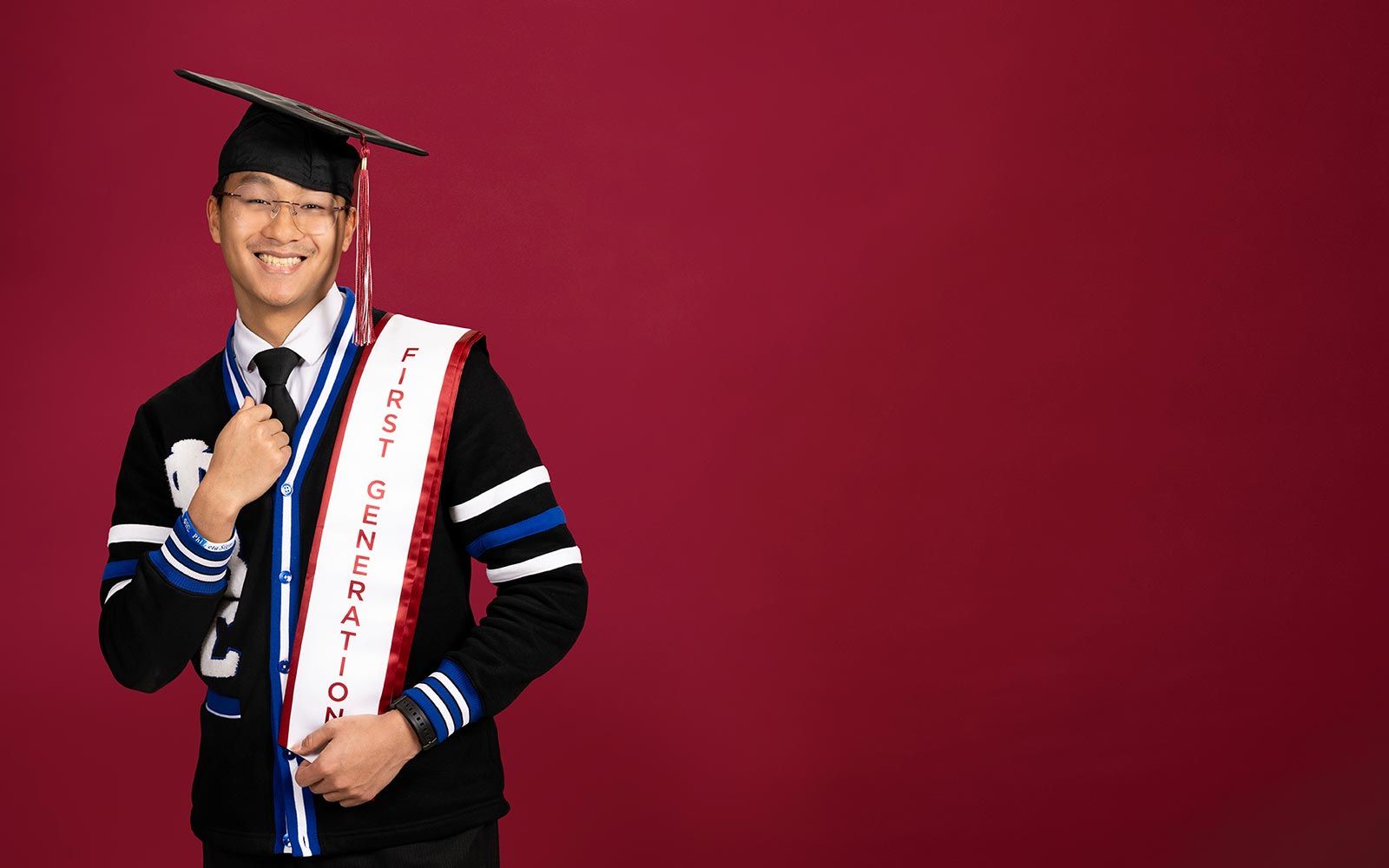 A TWU student wearing a graduation cap and a sash which says 'First Generation'