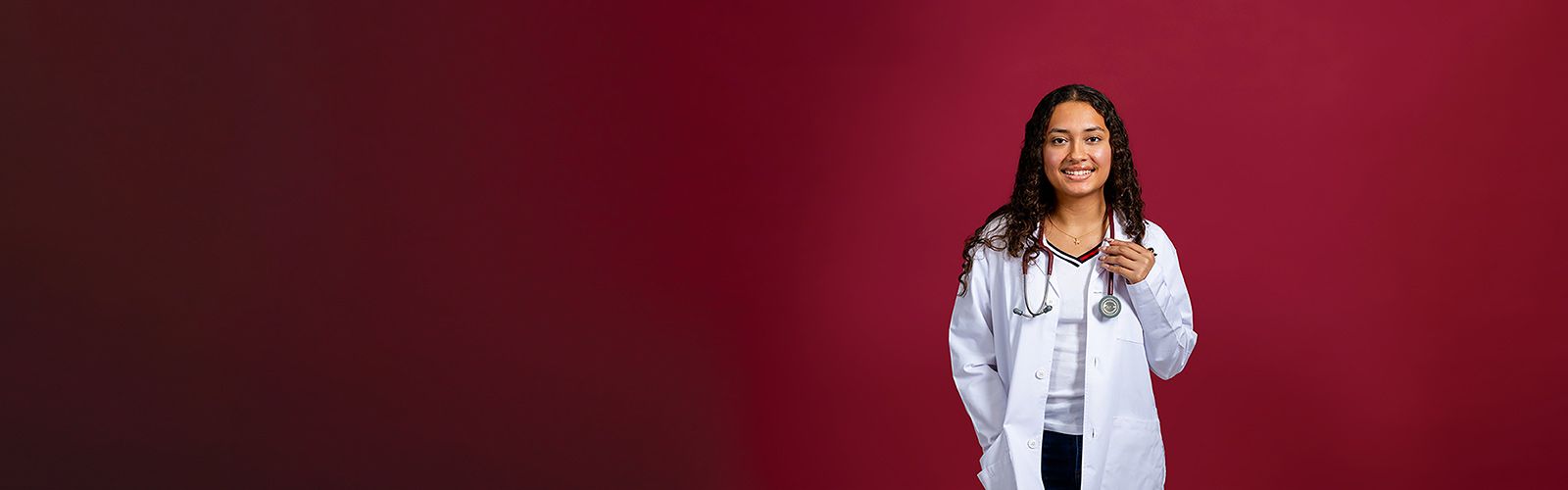 A TWU healthcare student in a university branded lab coat