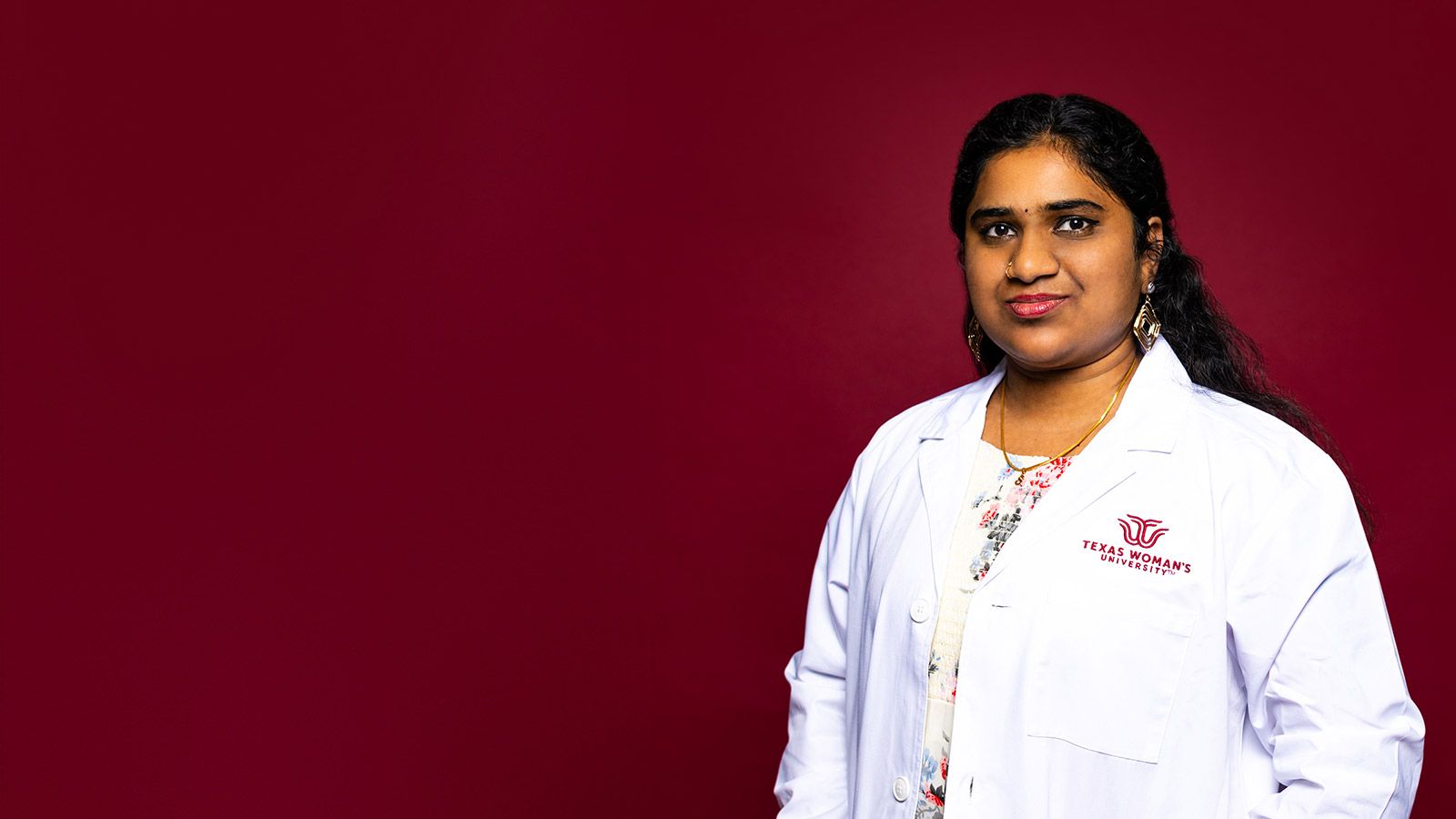 A TWU student wearing a lab coat